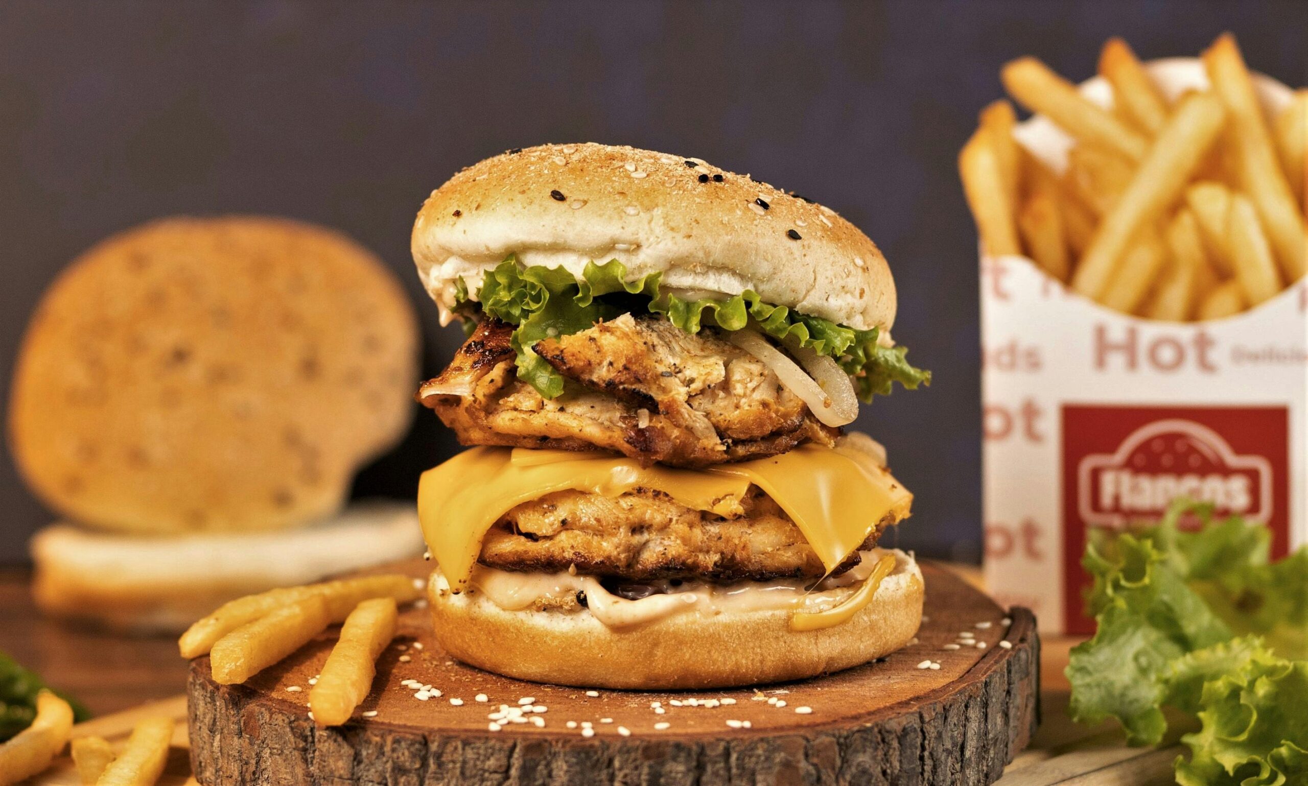 A Delicious Cheese Burger with Lettuce on a Wooden Chopping Board