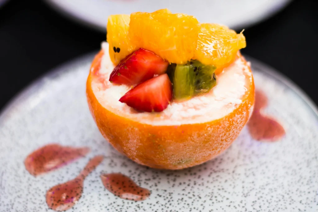 Poached peaches with vanilla cream and raspberry sorbet